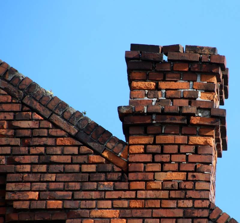 Damaged chimney on an Jessup home showing cracks and missing mortar